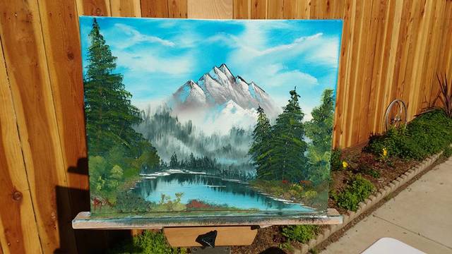 Painting of mountain and pond with trees.